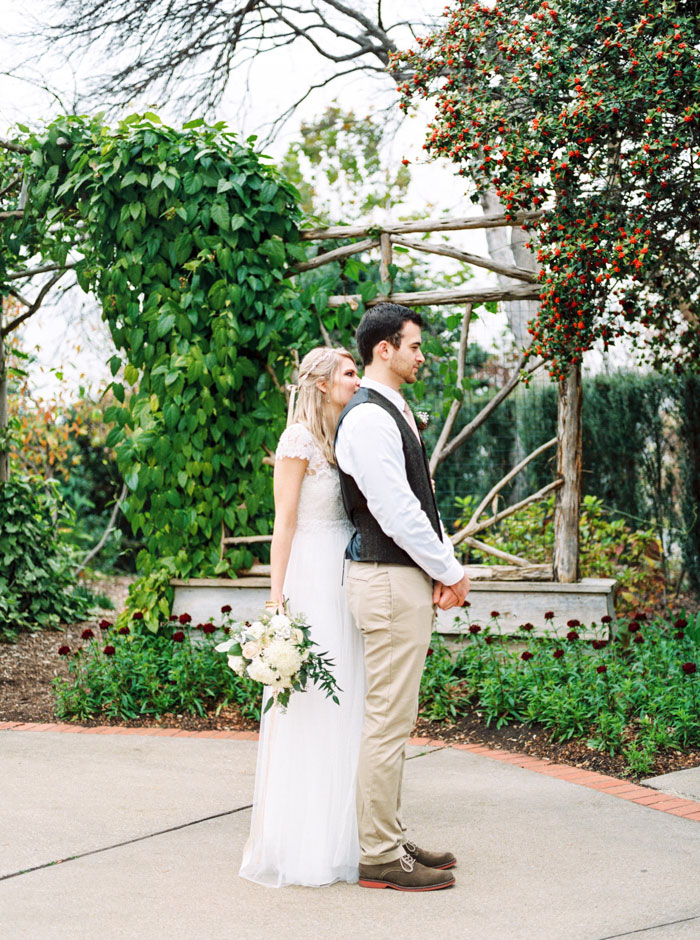 bride standing behind groom