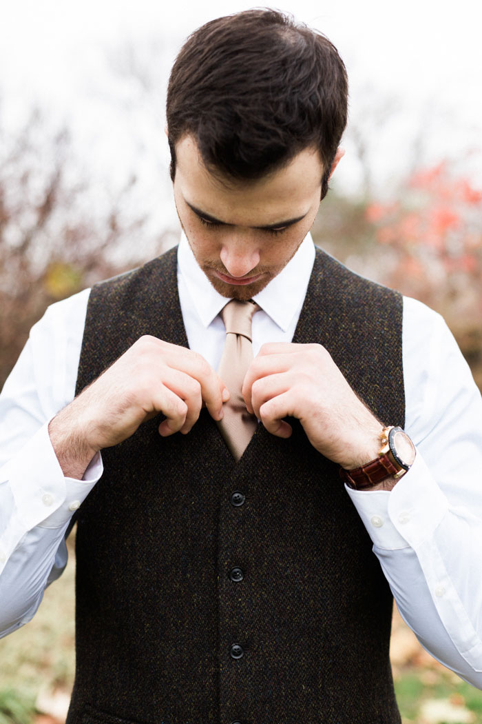 groom adjusting tie