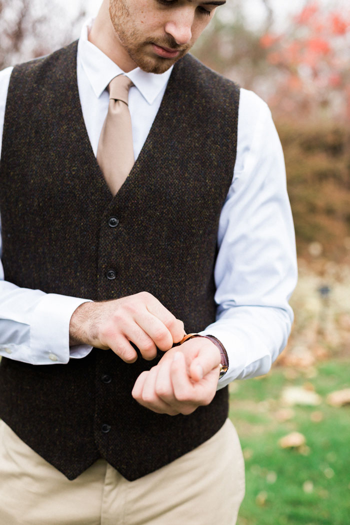 groom adjusting watch