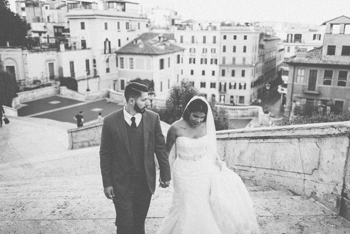 bride and groom climbing steps in Rome