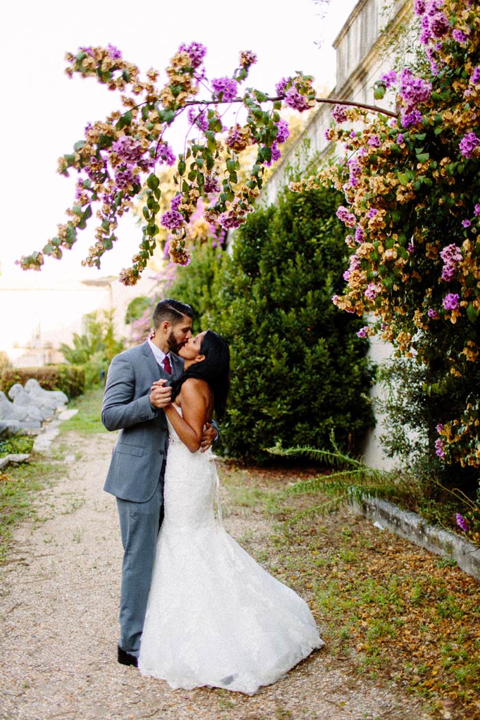 bride and groom kissing on country road