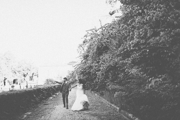 bride and groom walking down garden path