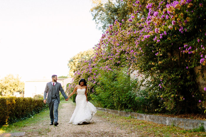 bride and groom walking down country road