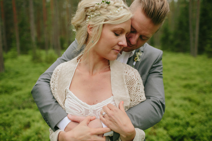 groom embracing bride from behind