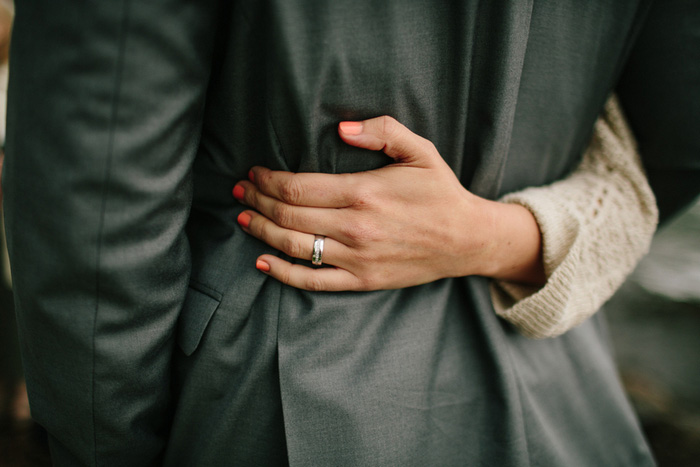 bride's hand on groom's back