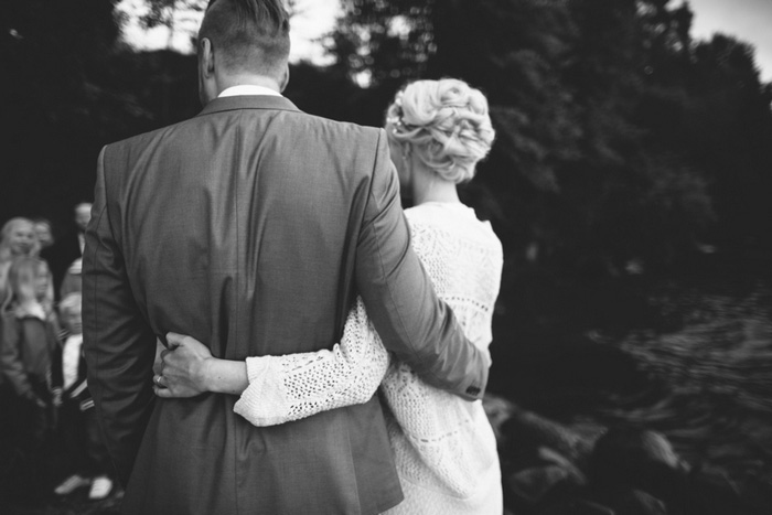 bride and groom with arms around each other's waists