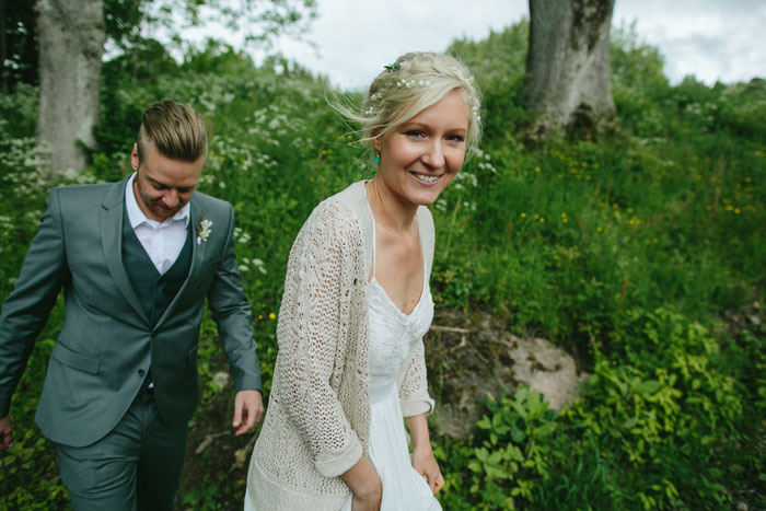 bride and groom walking in the woods