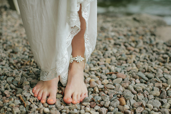 bride's feet on rocky beach