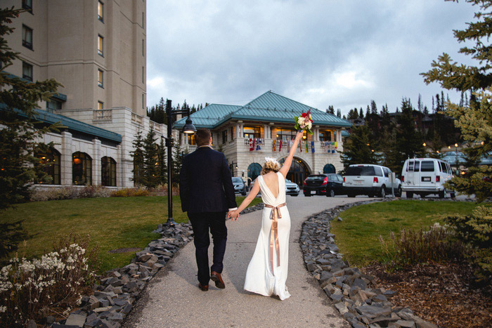 bride raising bouquet in the air