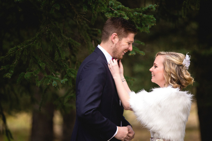 bride adjusting groom's bow tie