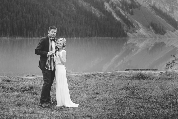 black and white bride and groom portrait in front of Lake Louise