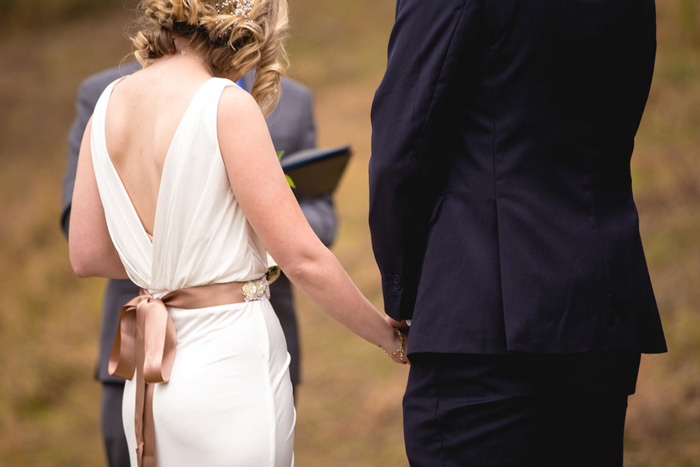 bride and groom holding hands during elopement ceremony