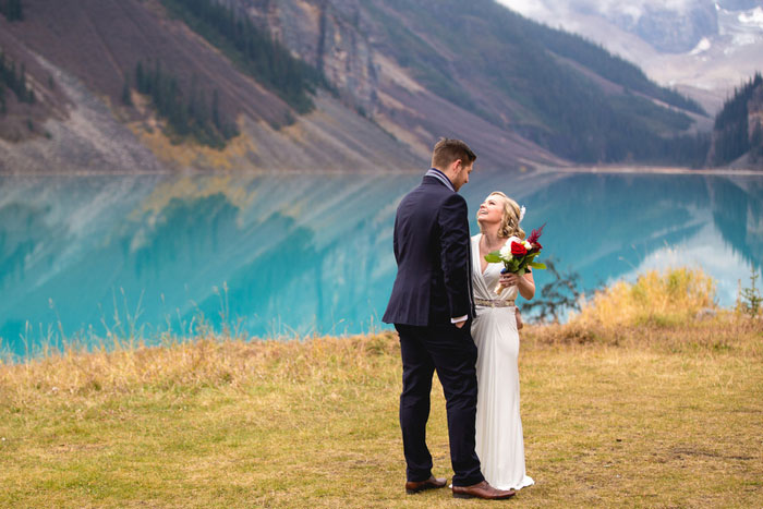 bride and groom in front of Lake Louise