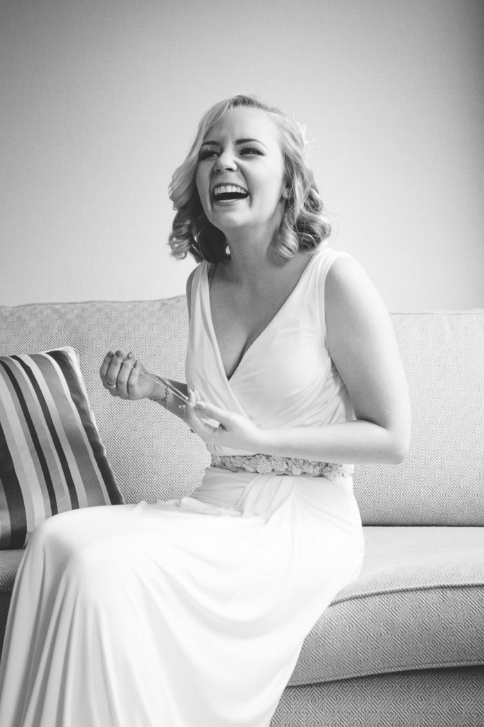 bride sitting on couch laughing