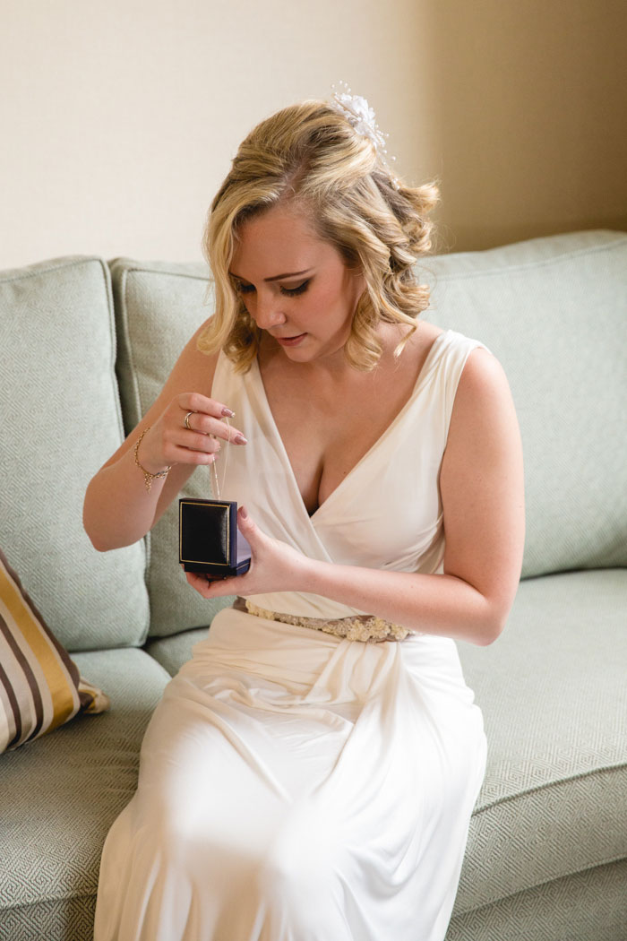 bride pulling necklace out of box