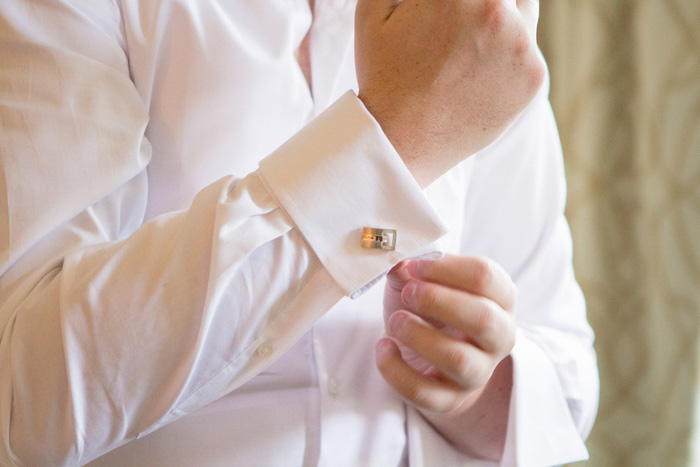 groom adjusting cuff links