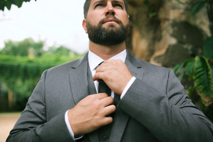 groom adjusting tie