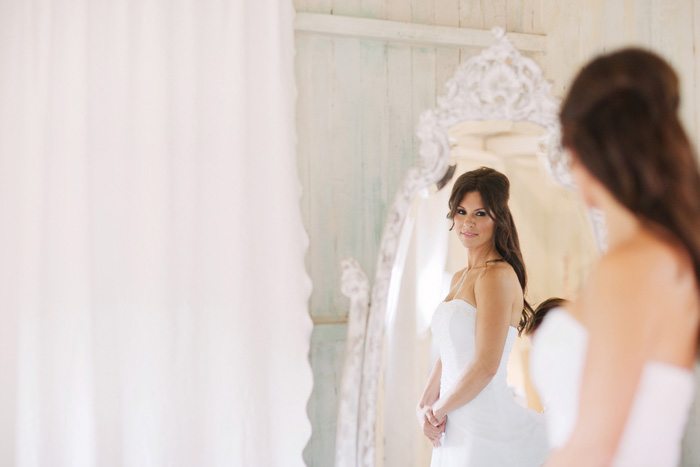 bride looking at herself in mirror