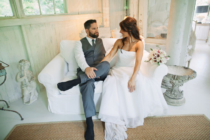 bride and groom sitting oncouch