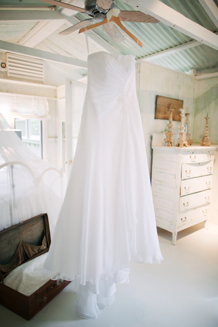 wedding dress hanging up in cottage