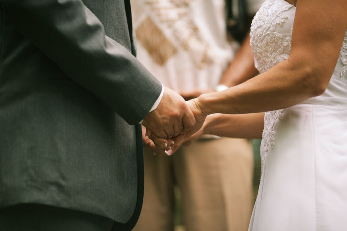 bride and groom holding hands during elopement ceremony