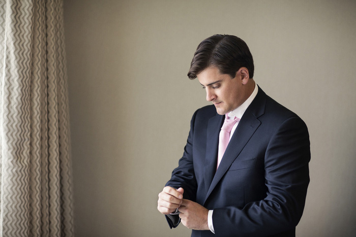 groom adjusting cuffs