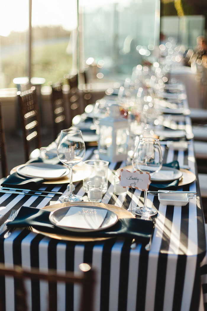 wedding table setting with black and white striped tablecloth