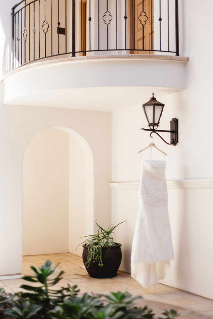 wedding dress hanging on light