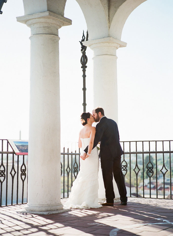 bride and groom kissing on terrace