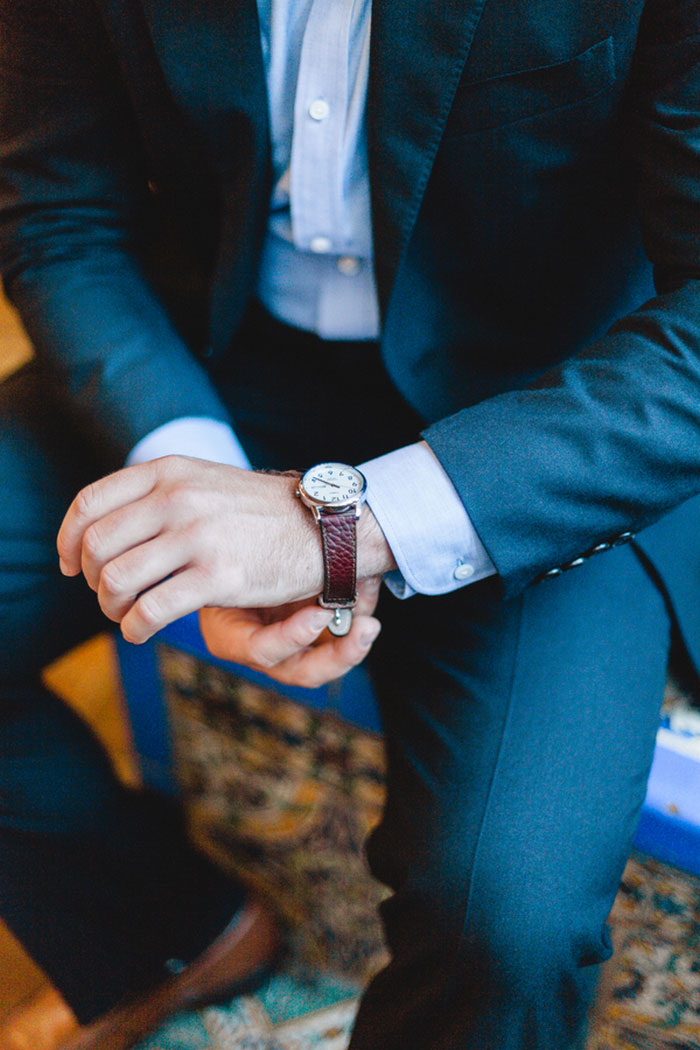 groom adjusting watch