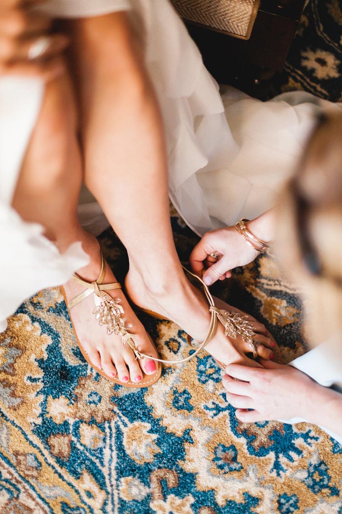 bride getting her shoes put on