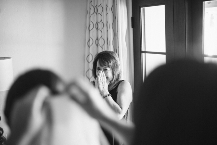 emotional mother of the bride watching veil being put on