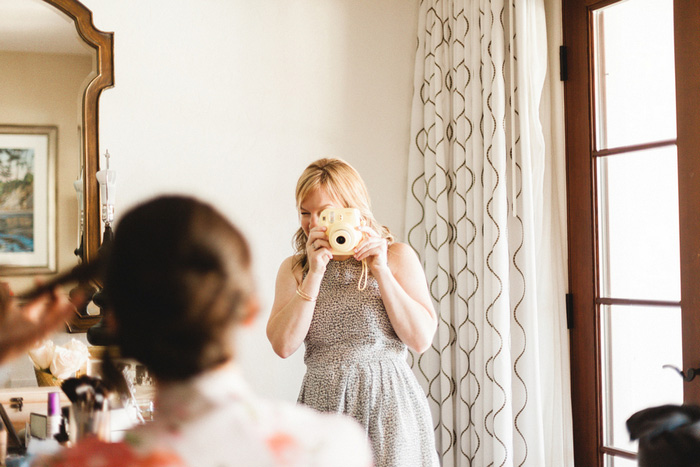 bridesmaid photographing bride