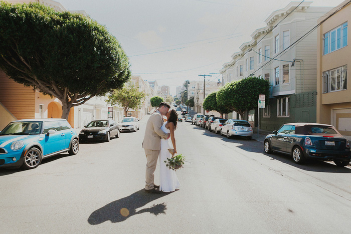 bride and groom kissing in San Francisco street