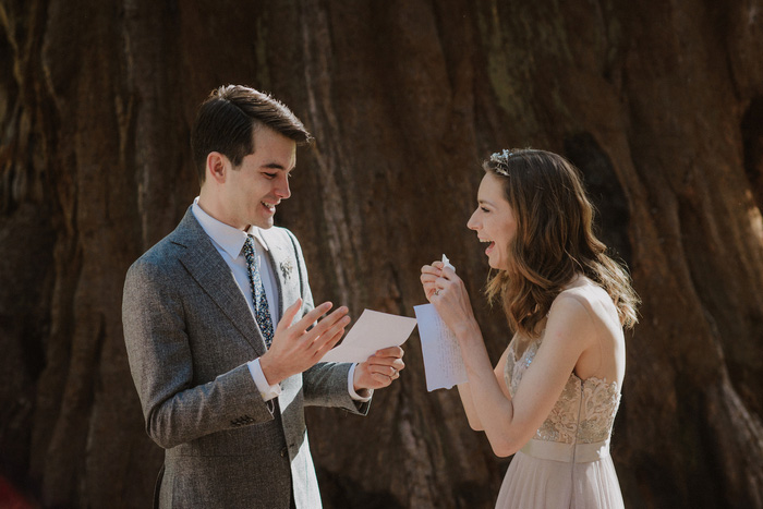 bride laughing during groom's vows