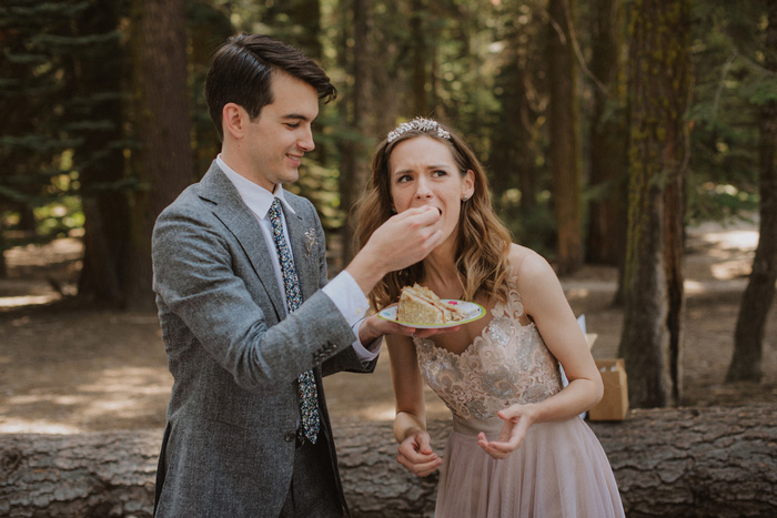 groom feeding bride cake