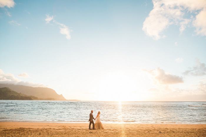 bride and groom walking on the beach