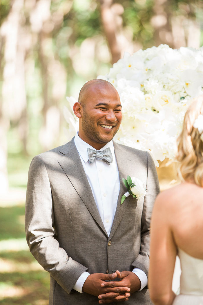 groom smiling at bride during wedding ceremony
