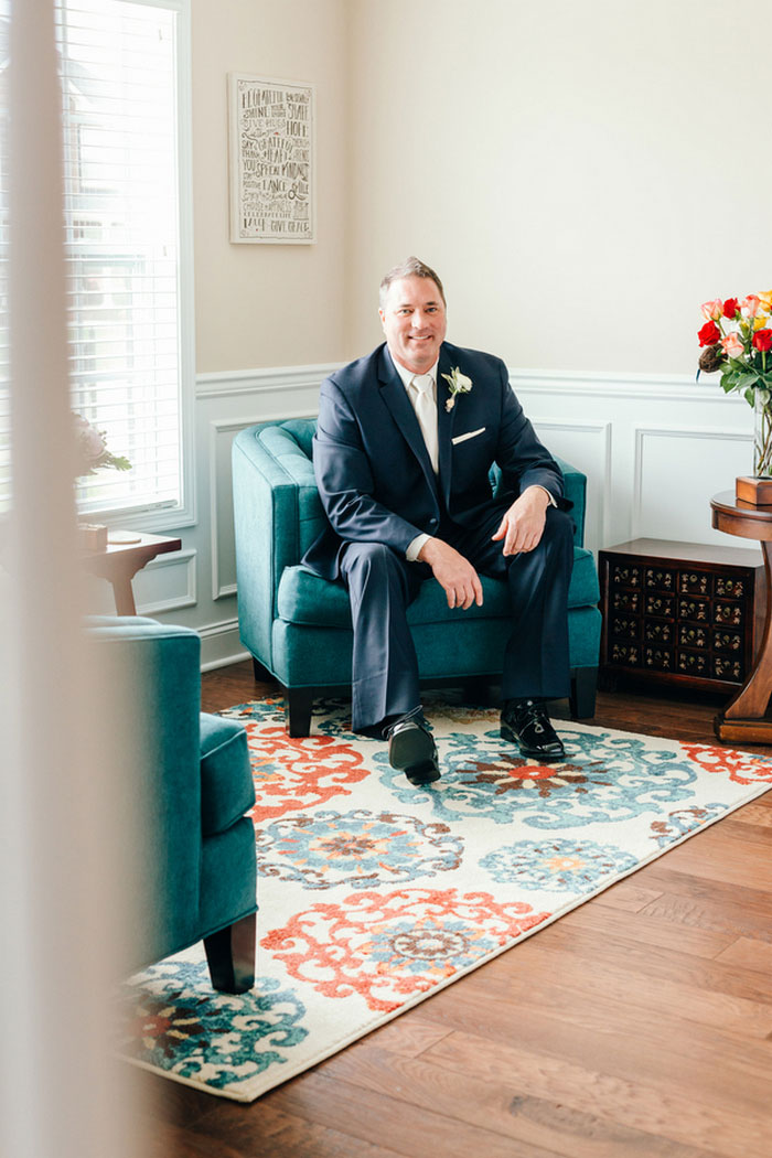 groom sitting in chair