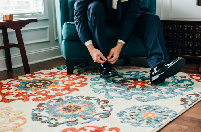 groom tying shoe