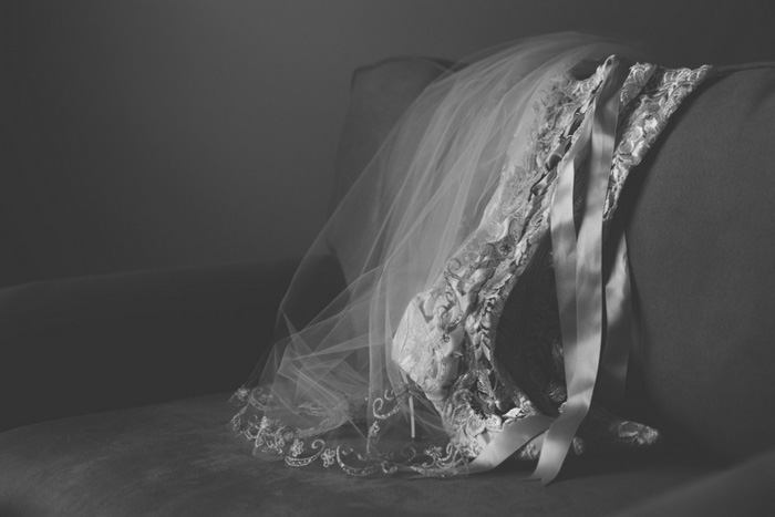 veil and wedding dress over back of chair