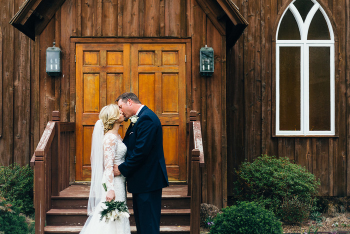 bride and groom portrait kissing outside church