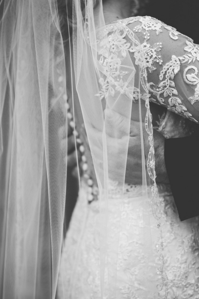 groom's hands on bride's back