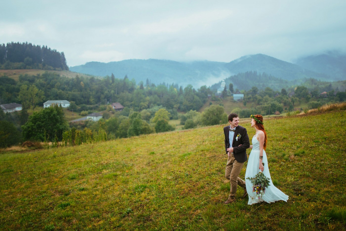 bride and groom walking on grass