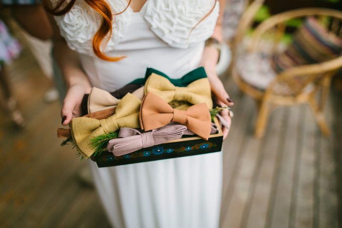 bride holding box of bow ties