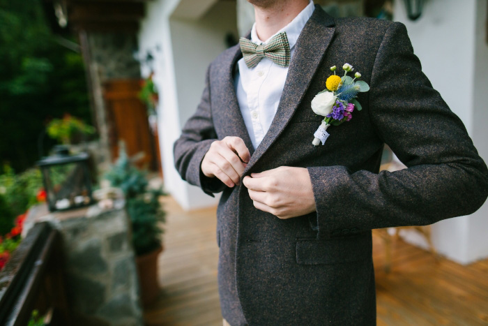 groom buttoning jacket