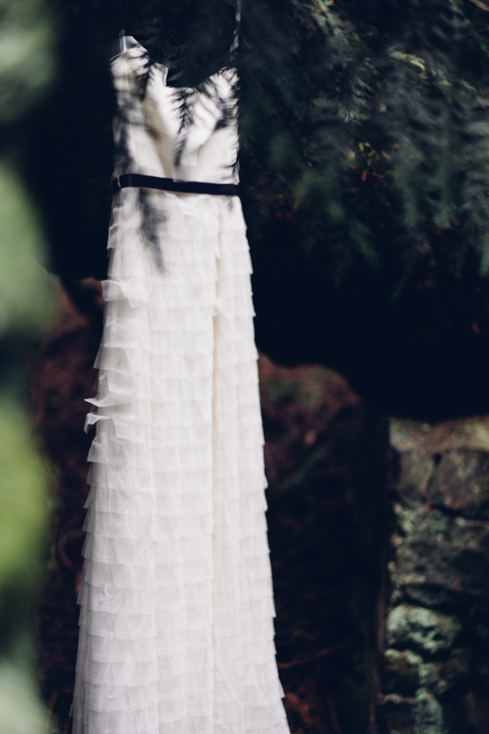 wedding dress hanging up on the woods