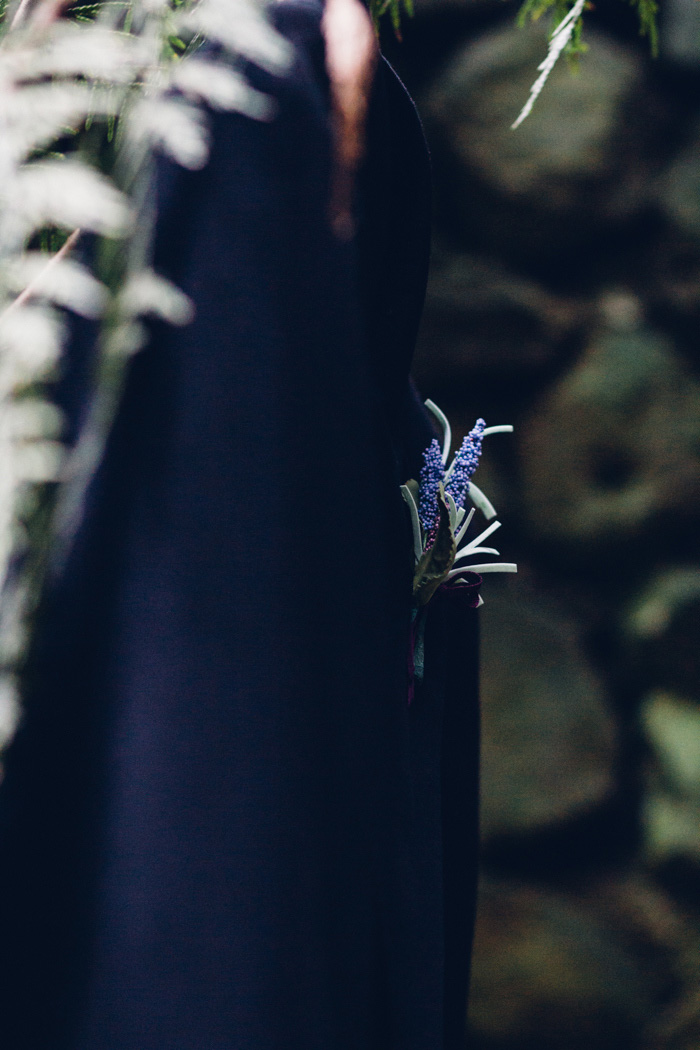 groom's suit jacket hanging up in the woods