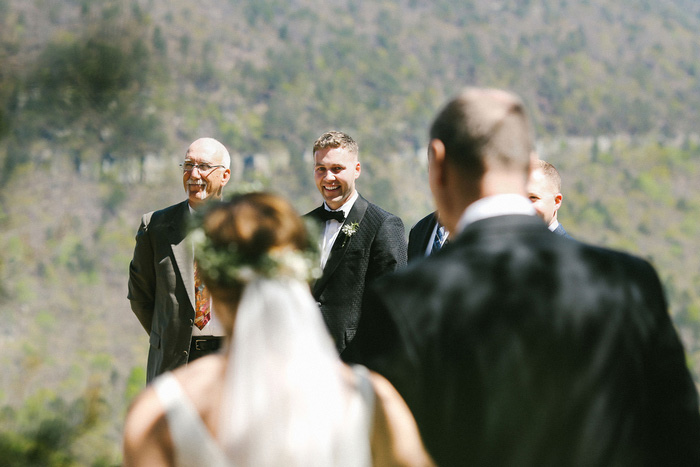 groom watching bride walk down the aisle