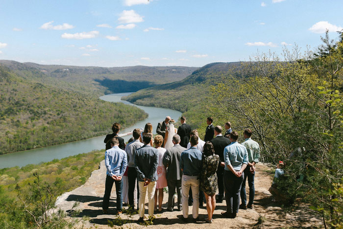 guests standing at outdoor wedding ceremony